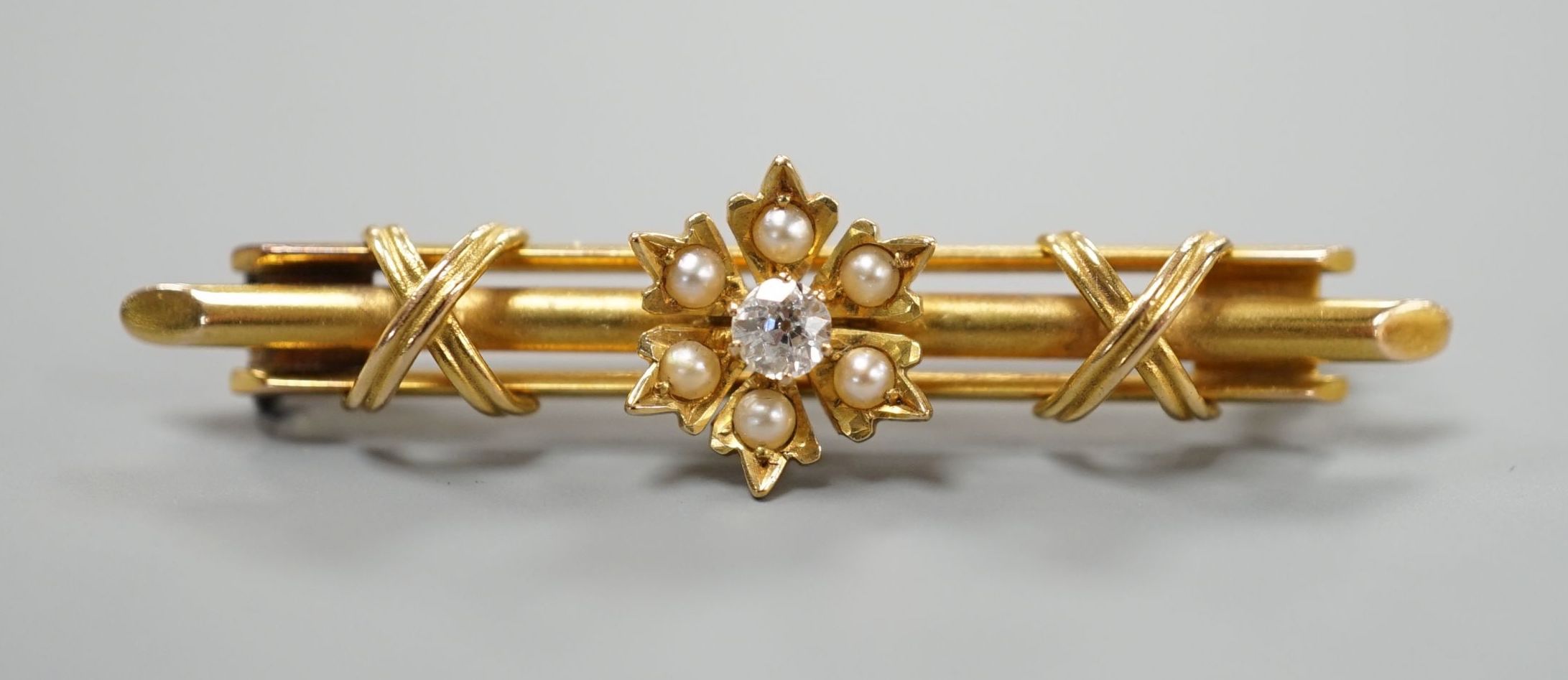 A Victorian 15ct, diamond and seed pearl set flower head bar brooch, 44mm, gross weight 4.3 grams.